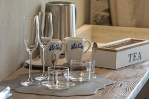 a table with wine glasses and a tea set on it at Stellio Affittacamere - Guest House in Riomaggiore