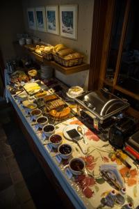 a buffet with many different types of food on a table at Estalagem Vila Suzana - Quadra de Beach Tennis Indoor in Canela