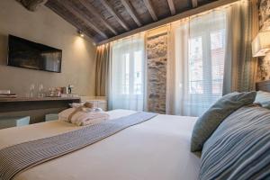 a bedroom with a large white bed with a window at Stellio Affittacamere - Guest House in Riomaggiore