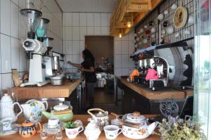 a woman standing in a kitchen preparing food in a kitchen at Cunda Mavi Hotel in Ayvalık