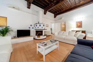 a living room with white furniture and a fireplace at Rental in Rome - Bramante Luxury in Rome