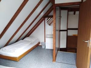 a bedroom with a bunk bed in a attic at Waldeck in Frankenau