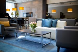 a living room filled with furniture and a table at The Park Hotel London in London