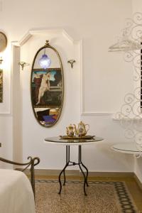 a table in a room with a mirror at B&B Lido Liberty - "L'abbraccio di Klimt" in Lido di Ostia