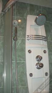 a shower with a glass door and a shower coil at Однокомнатная квартира у моря in Gagra