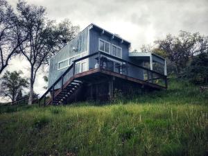 a house sitting on top of a grassy hill at Sequoia Resort in Badger