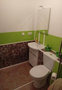 a bathroom with a white toilet and a sink at Santos in Kappel-Grafenhausen