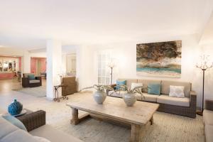 a living room with a couch and a table at Sugar Bay Barbados - All Inclusive in Bridgetown