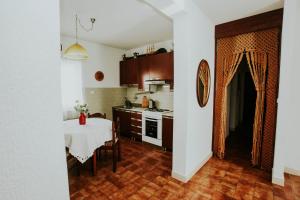 a kitchen with a table and a kitchen with a dining room at Apartments Doulos in Splitska