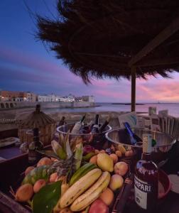 a tray of fruit on a table near the beach at A Casa Ta Valeria in Gallipoli