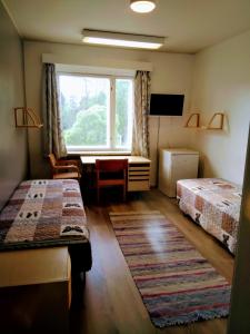 Ένα ή περισσότερα κρεβάτια σε δωμάτιο στο Hostel Vanha Koulu