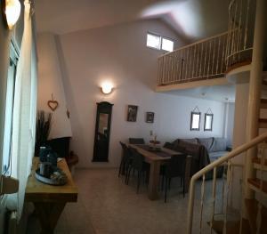 a living room with a table and a dining room at Nirvana house in Sani Beach
