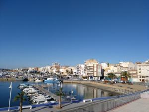 a marina with boats in the water and buildings at Estupendo piso en L'AMPOLLA in L'Ampolla