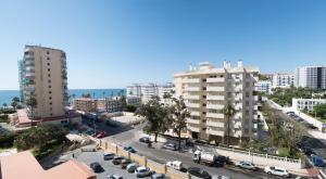 an aerial view of a city with buildings and the ocean at Apart EAM Maite 3 in Benalmádena