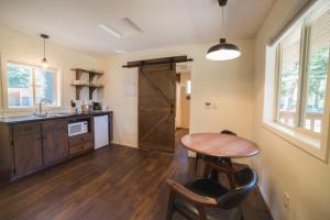 a kitchen with a wooden table and a wooden door at Eagle Cap Chalets in Joseph