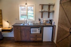 a kitchen with a sink and a microwave at Eagle Cap Chalets in Joseph