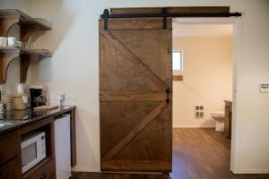 a sliding barn door in a kitchen with a toilet at Eagle Cap Chalets in Joseph