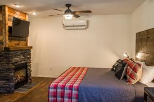 a bedroom with a bed and a fireplace at Eagle Cap Chalets in Joseph