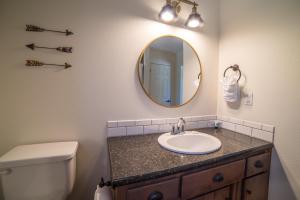 a bathroom with a sink and a mirror at Eagle Cap Chalets in Joseph