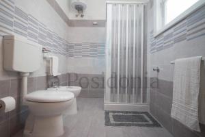 a white bathroom with a toilet and a shower at LaCassiopea in Donnalucata +34 photos