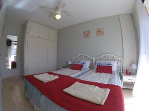 a bedroom with a large bed with red pillows at Olivia Sunset Playa in Puerto de Santiago +70 photos
