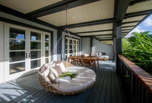 a porch with a rattan chair and a table at The Island House in Nassau