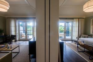 a hotel room with a bed and a living room at The Island House in Nassau