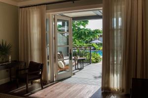 a living room with a door open to a patio at The Island House in Nassau