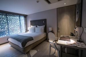Postel nebo postele na pokoji v ubytování Hotel CityFlats