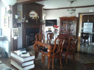 a dining room with a table and chairs and a fireplace at gite des iles in Matane