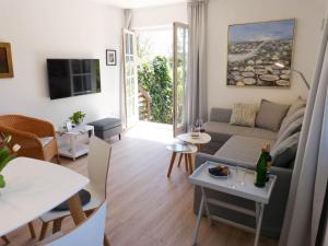 ein Wohnzimmer mit einem Sofa und einem Tisch in der Unterkunft Ferienwohnung *Reethuk* in Norddorf