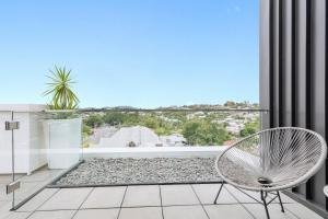 a chair on a balcony with a view at The Beetson Hotel in Brisbane +26 photos