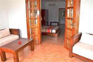 a living room with two chairs and a couch at Britannia Hotel in Grand'Anse Praslin