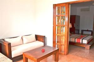 a living room with a couch and a table at Britannia Hotel in Grand'Anse Praslin