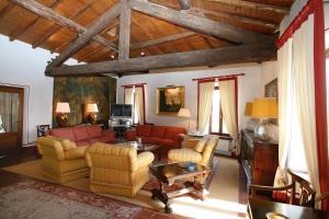 a living room with a couch and chairs and a tv at Locanda San Vigilio in Garda