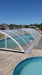 a swimming pool with a metal cover on a house at Rangiora Eco Holiday Park in Fernside