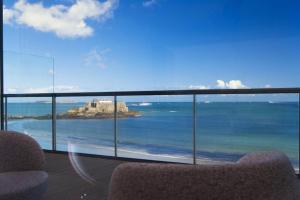 a view of the ocean from a balcony with two chairs at Oceania Saint Malo in Saint Malo