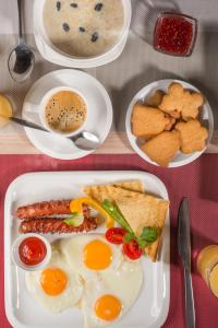 a plate of breakfast food with eggs and toast at Futuro Hotel Bishkek in Bishkek