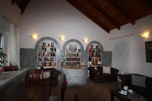 a living room with chairs and a table and bookshelves at Armarova Ihre Ferienpension in Cuxhaven