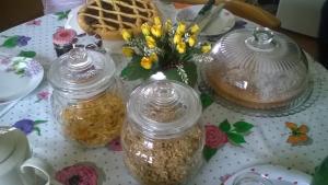 a table with two jars of food and flowers on it at Agriturismo bio Verde Armonia in Montemarciano