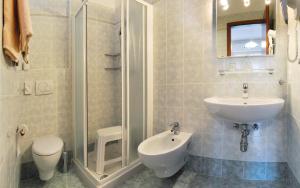 a bathroom with a sink and a shower and a toilet at Villa Flora in Levico Terme