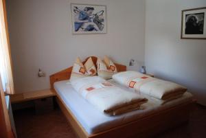 a bedroom with a bed with two pillows on it at Apartment Maierhof in Flirsch
