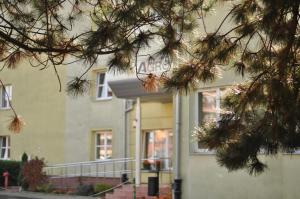 a branch of a pine tree in front of a building at AGRO obiekt hotelowy in Wrocław