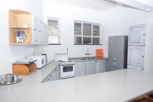 a large kitchen with white appliances and white cabinets at Seabrook 401 Margate RSA in Margate