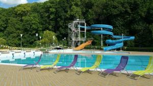 a swimming pool with a blue water slide at Chalupa Dolce Vita in Trutnov