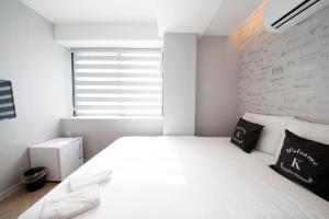 Postel nebo postele na pokoji v ubytování K-Guesthouse Seomyeon 1