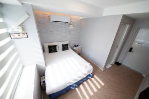 Postel nebo postele na pokoji v ubytování K-Guesthouse Seomyeon 1