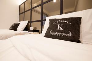 Postel nebo postele na pokoji v ubytování K-Guesthouse Seomyeon 1