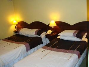 Säng eller sängar i ett rum på The Anchorage Guest House