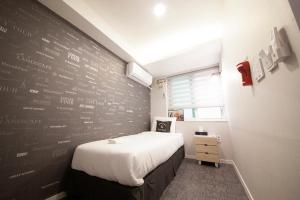 Postel nebo postele na pokoji v ubytování K-Guesthouse Seomyeon 1